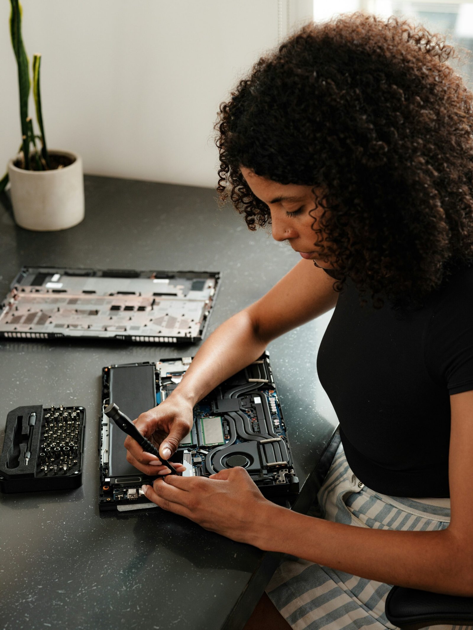 A woman sitting at a table using a cell phone